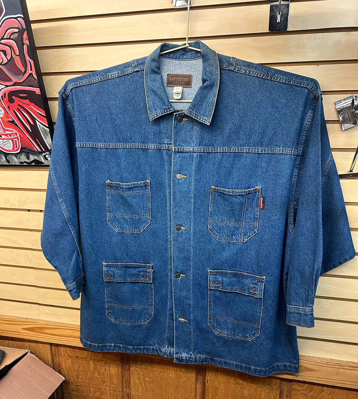 A Greystone denim work shirt in an extended size on a slatwall display.