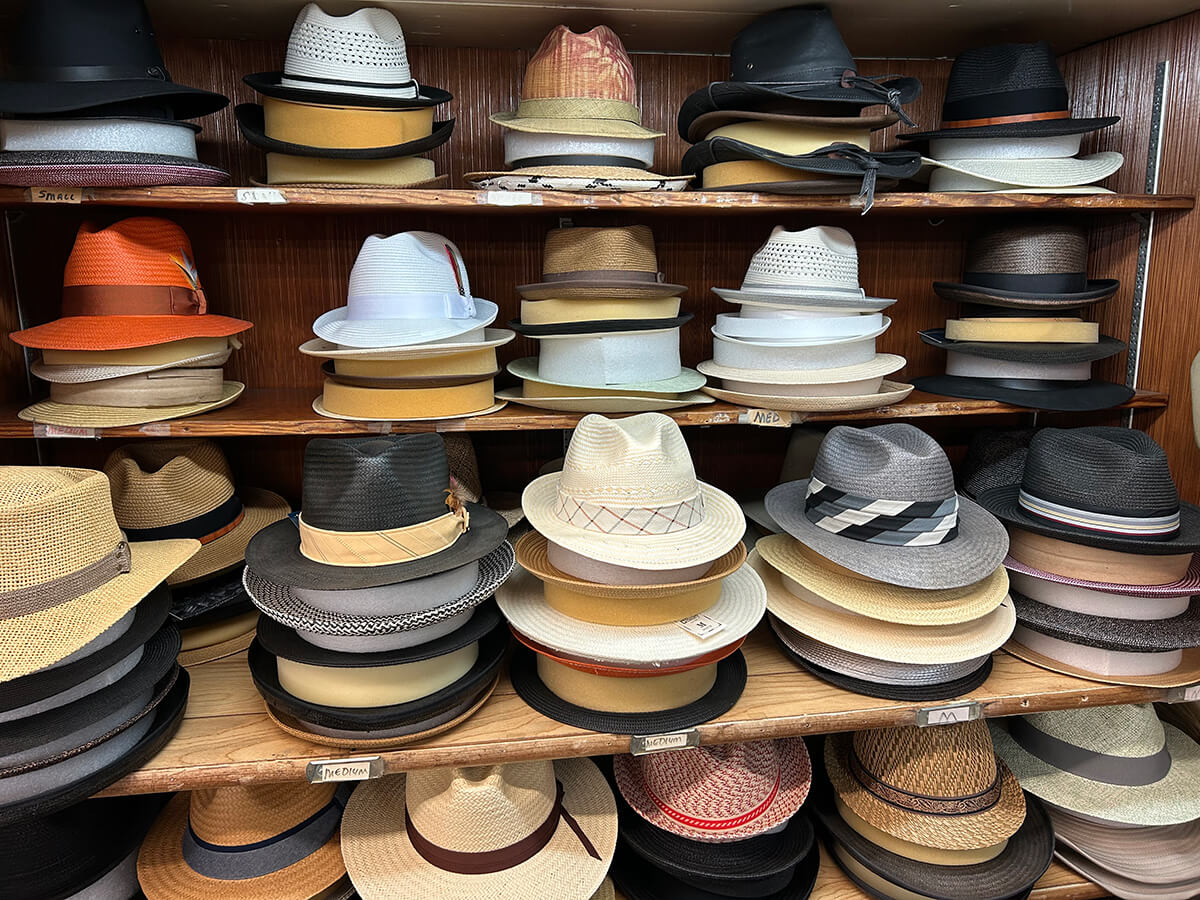 Shelves of fedoras, straw hats and dress hats at Kornfeld's.