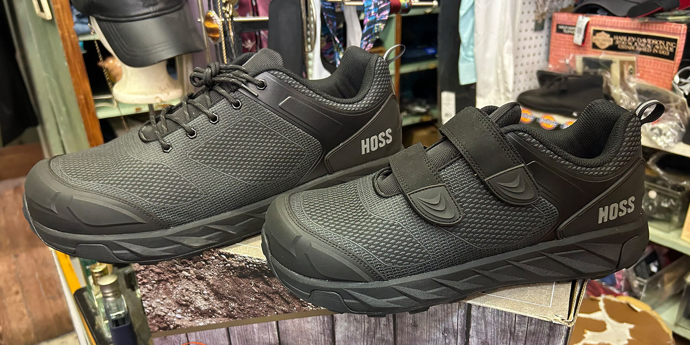 A pair of black HOSS athletic work shoes displayed on a shelf at Kornfeld's.