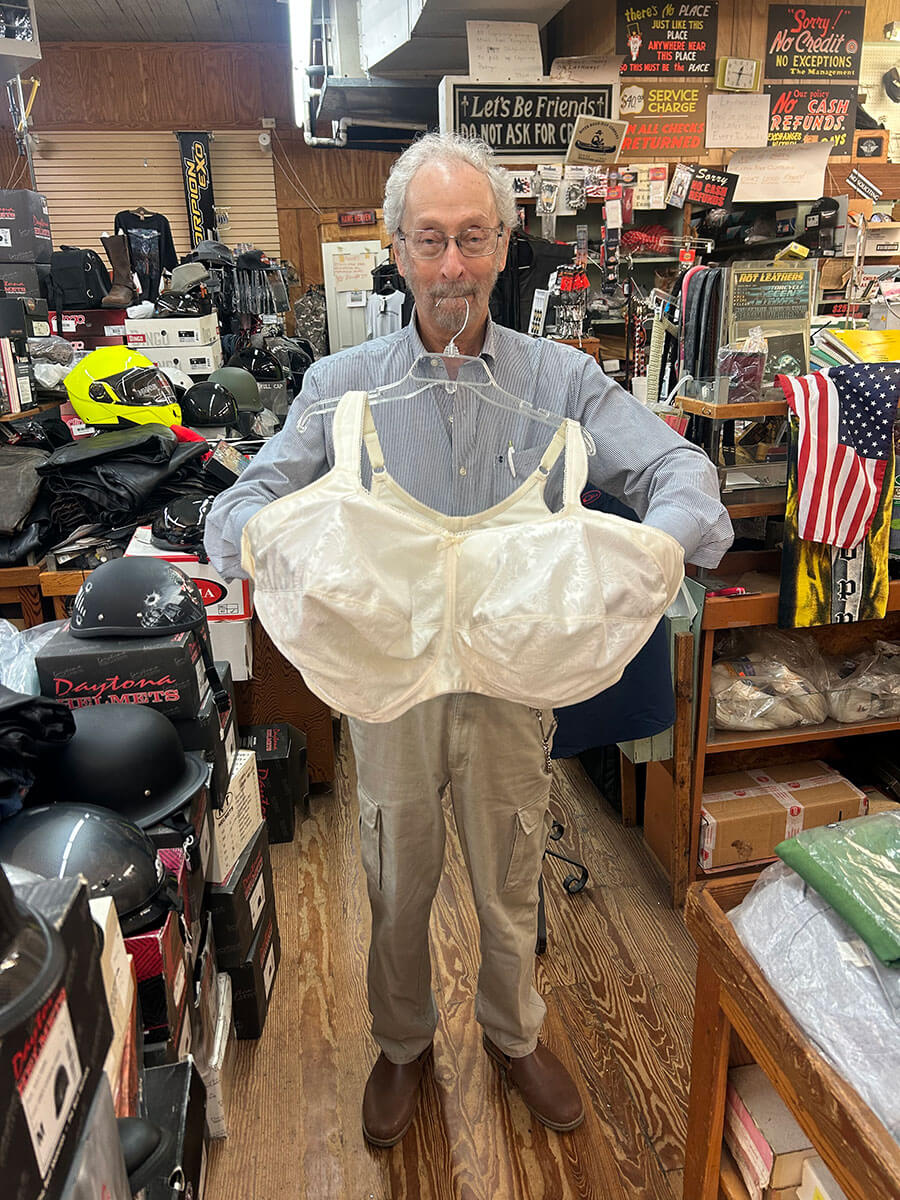 Bubba Kornfeld holding a women's extended-size garment.
