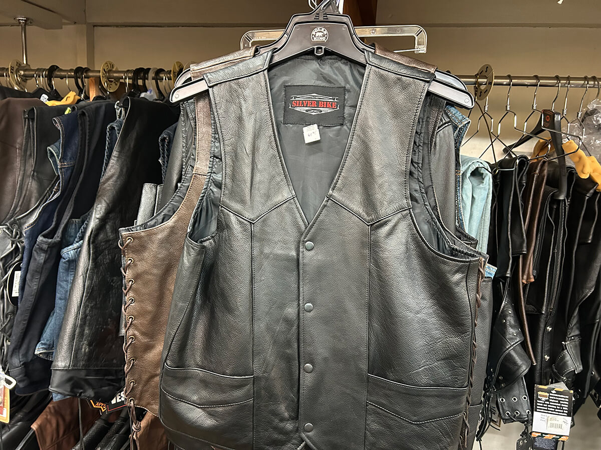 A black Silver Bike leather riding vest on a rack of vests at Kornfeld's.