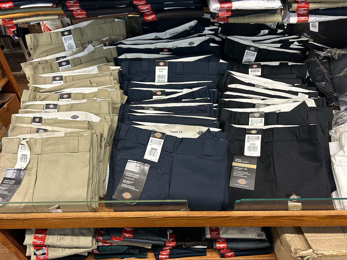 Folded Dickies short-sleeve twill work shirts in gray, navy and brown at Kornfeld's.